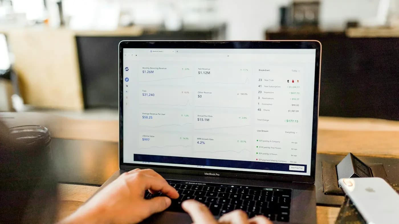 Hands on a laptop showing an advertising dashboard