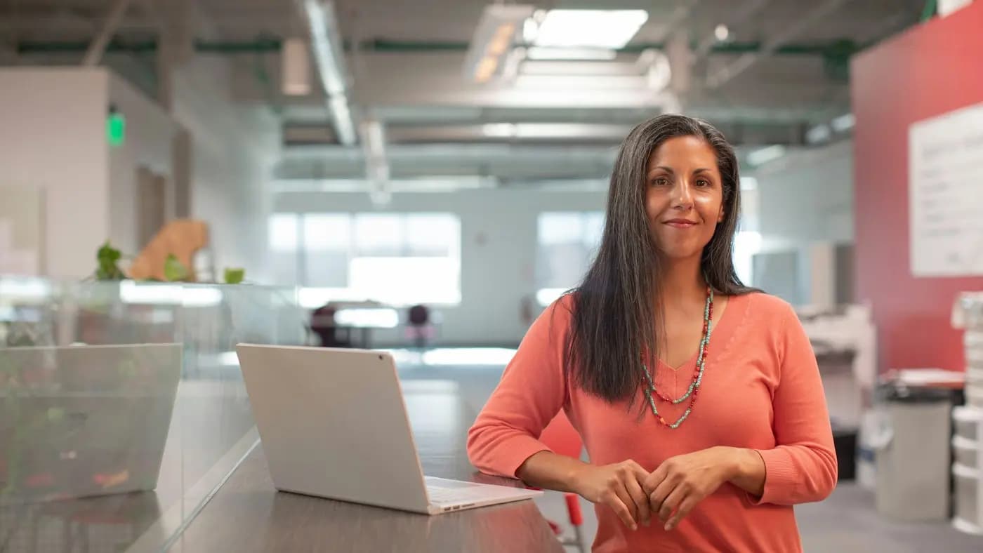 Professional working at a laptop in a bright office