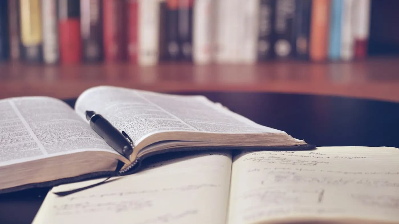 Open book with notes on a wooden table