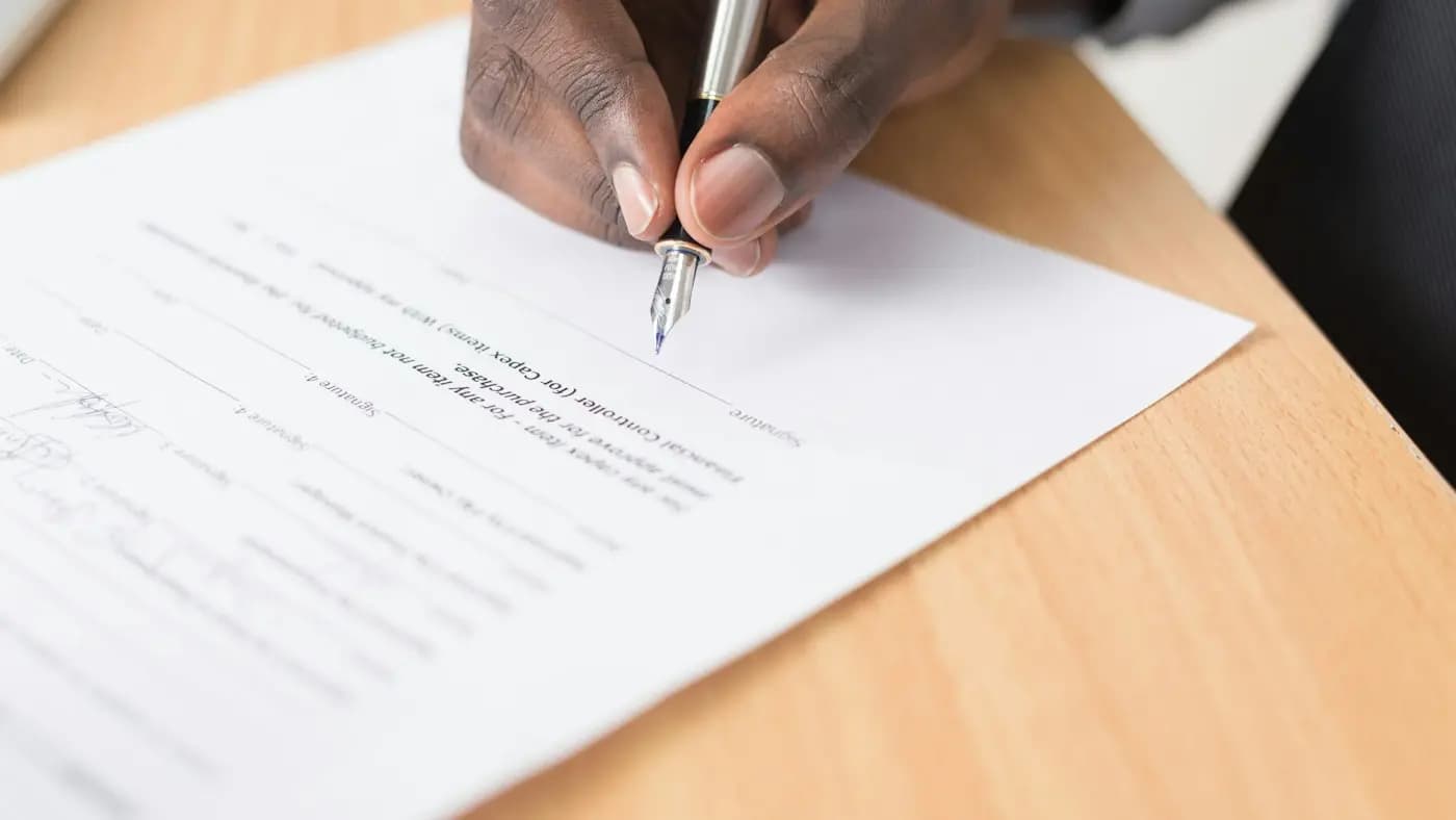 Hand writing with a pen on paper