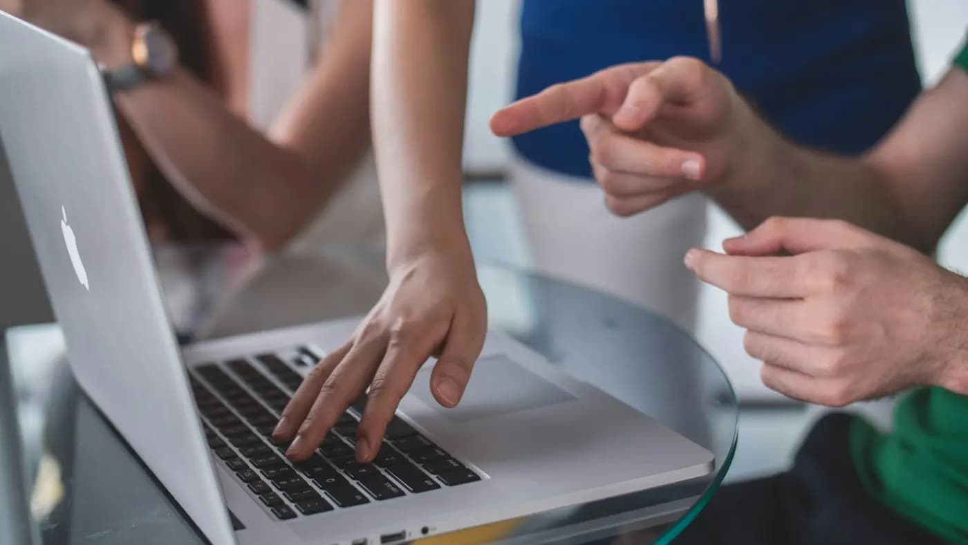 Hands on a laptop, pointing at the screen
