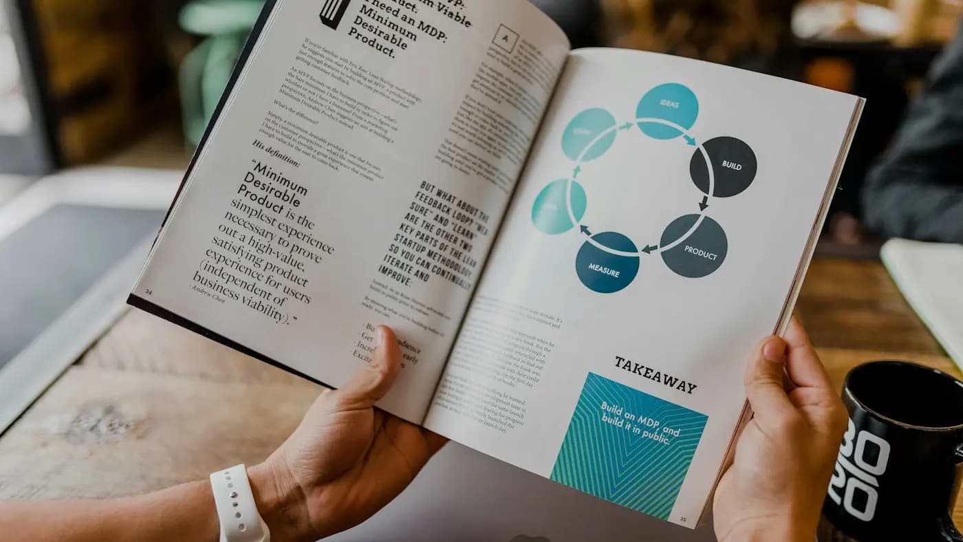Person reading a magazine with a diagram