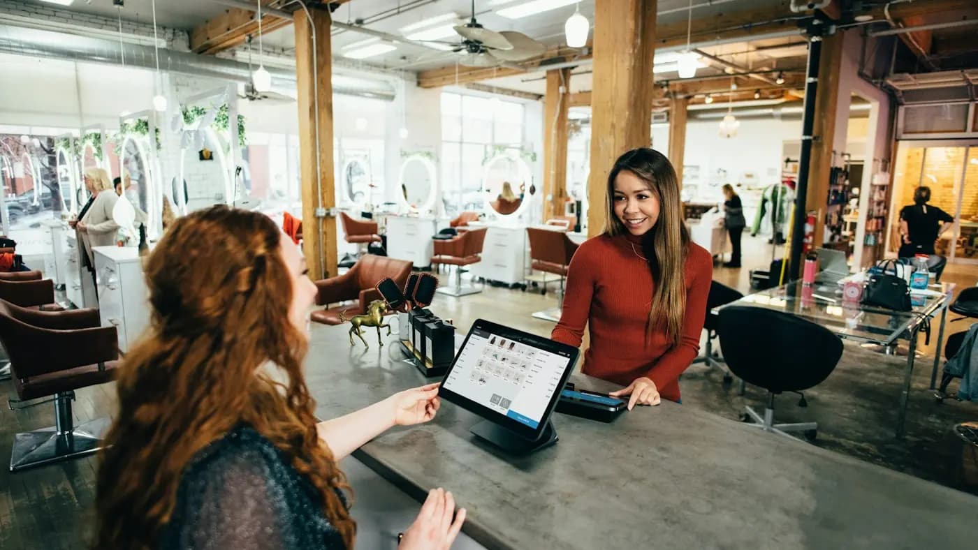 Shop assistant and customer using a tablet in a store