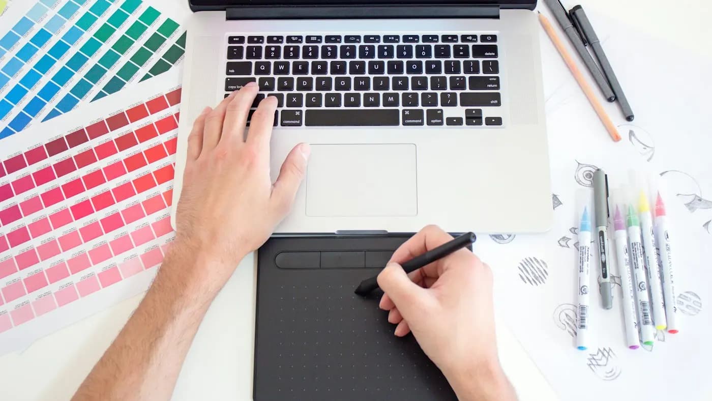Graphic tablet and colour swatches with a laptop