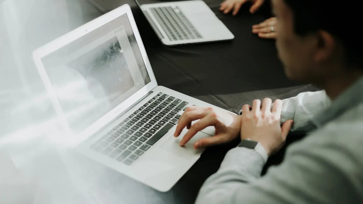 Hands working on a laptop