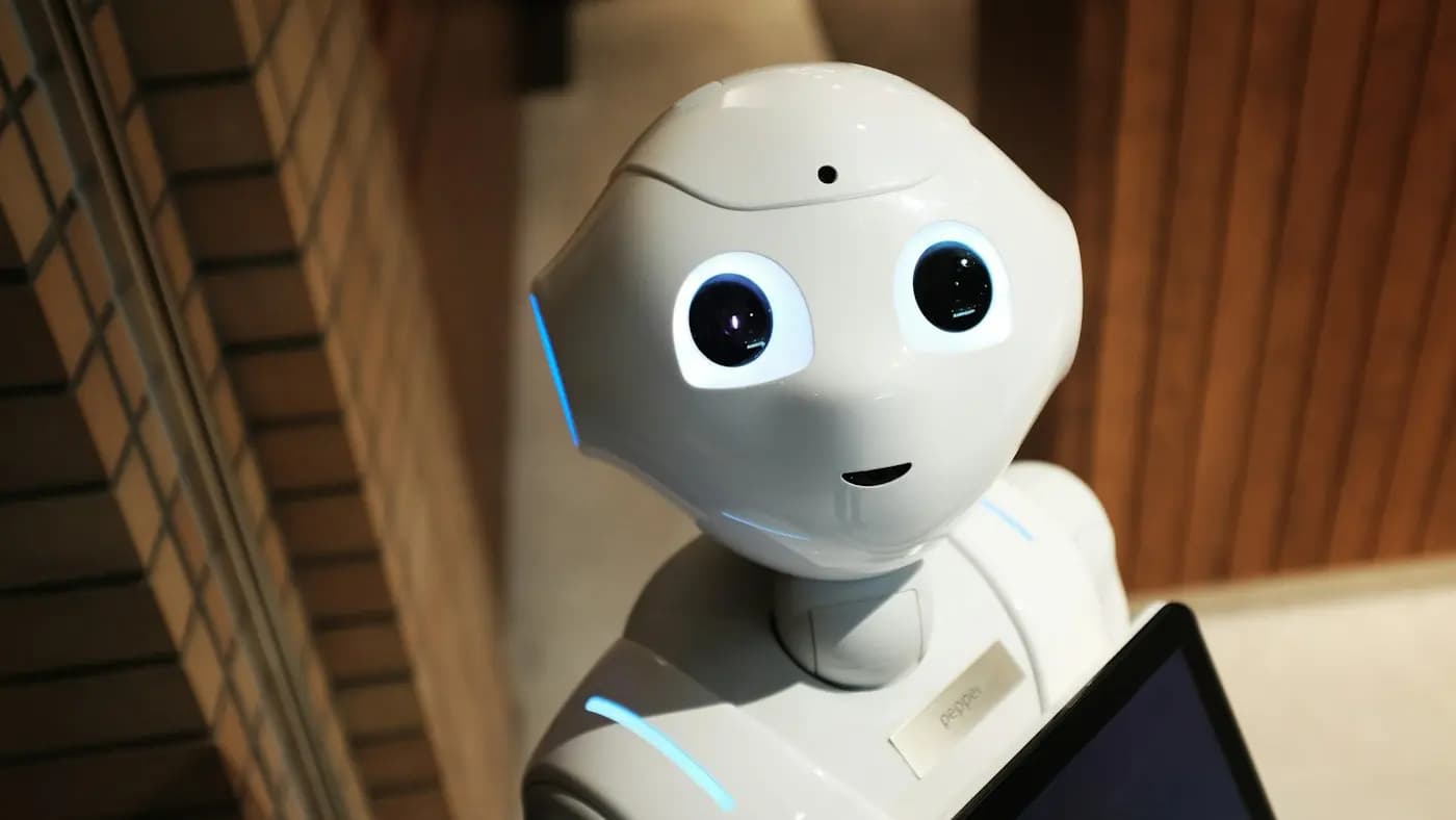 Small white humanoid robot with large eyes