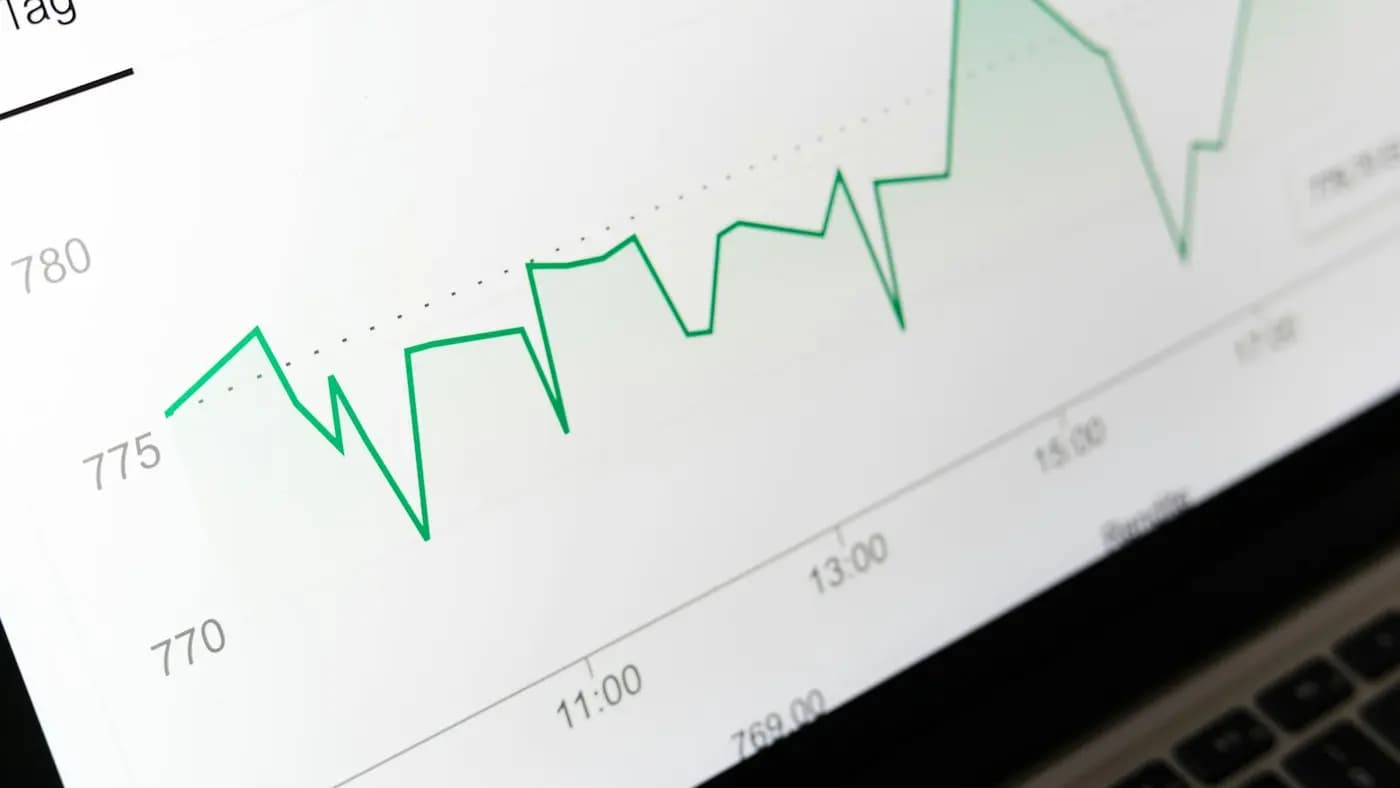 Green line chart showing marketing performance on a screen