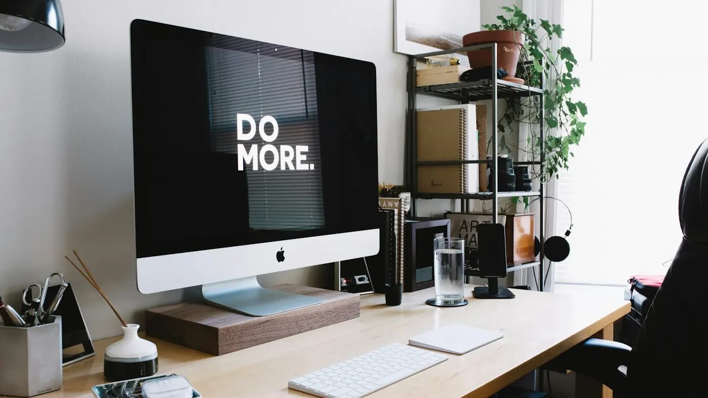 Desk with a monitor displaying the words do more