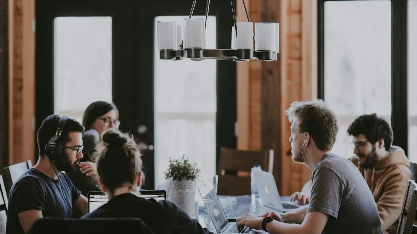 Group of people working together around a large table