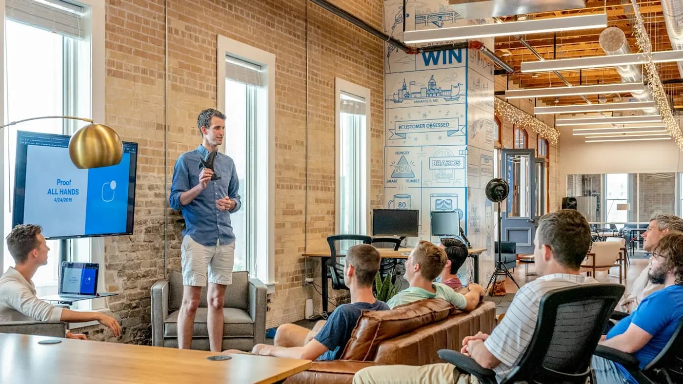 Speaker presenting to a small audience in a bright loft space