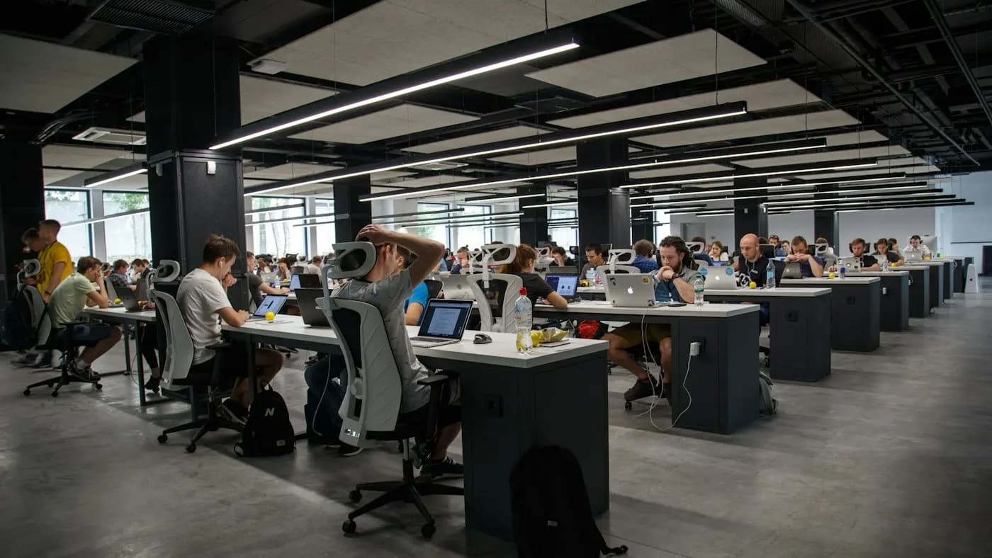 Large open plan office with many people working at desks