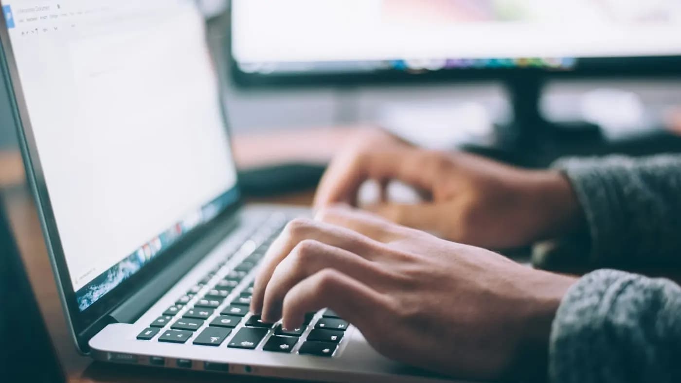 Person typing on a laptop keyboard